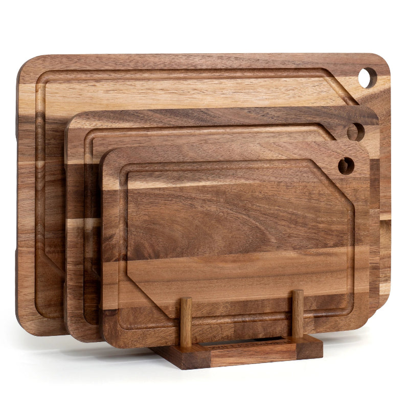 Set of 3 acacia wooden cutting boards with a stand on a white background