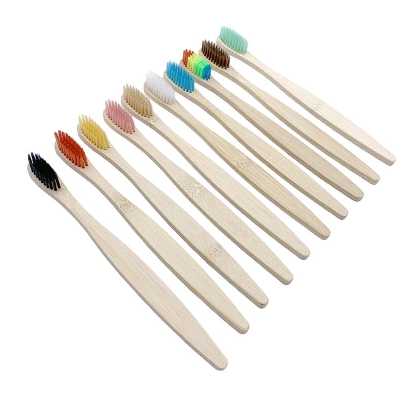 Set of bamboo toothbrushes with colored bristles on a white background
