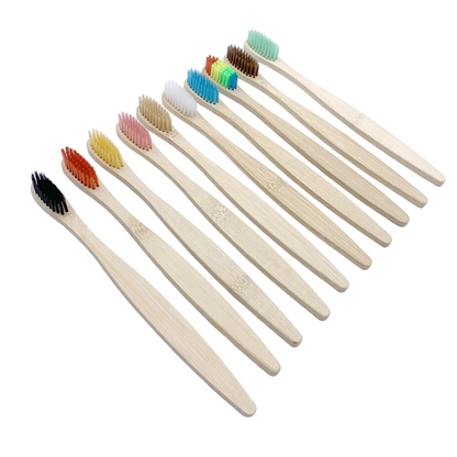 Set of bamboo toothbrushes with colored bristles on a white background