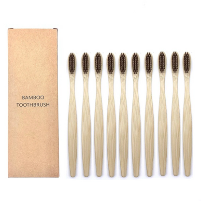 Set of bamboo toothbrushes with brown bristles and a cardboard box labeled 'Bamboo Toothbrush' on a white background.
