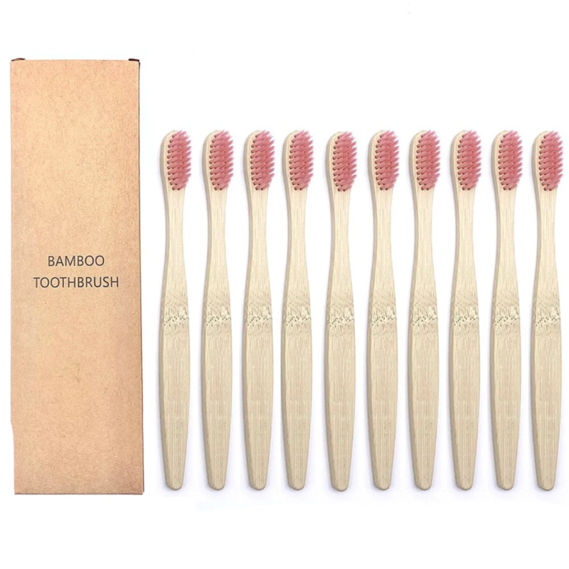 Set of bamboo toothbrushes with pink bristles and a cardboard box labeled 'Bamboo Toothbrush' on a white background.