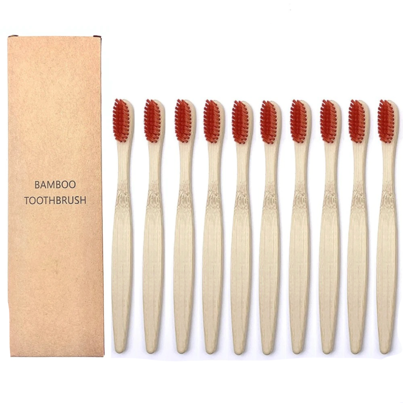 Set of bamboo toothbrushes with red bristles and packaging on a white background