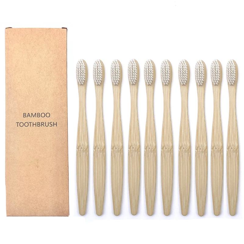Set of bamboo toothbrushes with white bristles with a cardboard box on a white background