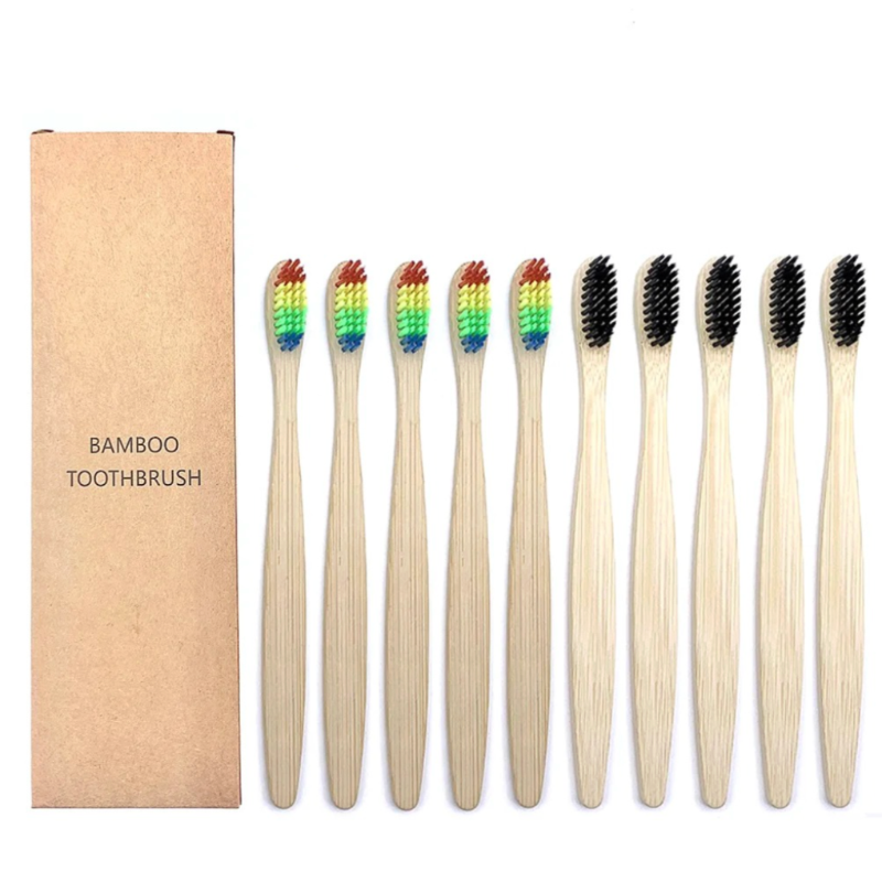 Set of bamboo toothbrushes with rainbow bristles and black bristles and a cardboard box labeled 'Bamboo Toothbrush' on a white background.