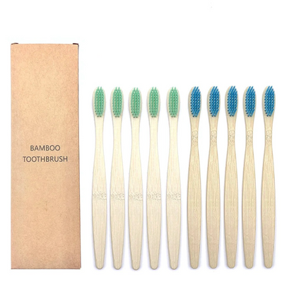 Set of bamboo toothbrushes with green and blue bristles, next to a cardboard box labeled 'Bamboo Toothbrush'.