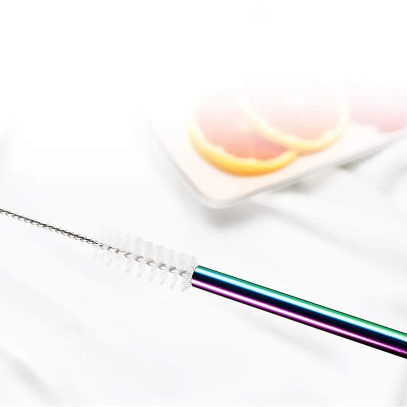 Rainbow straw with cleaning brush on a white background
