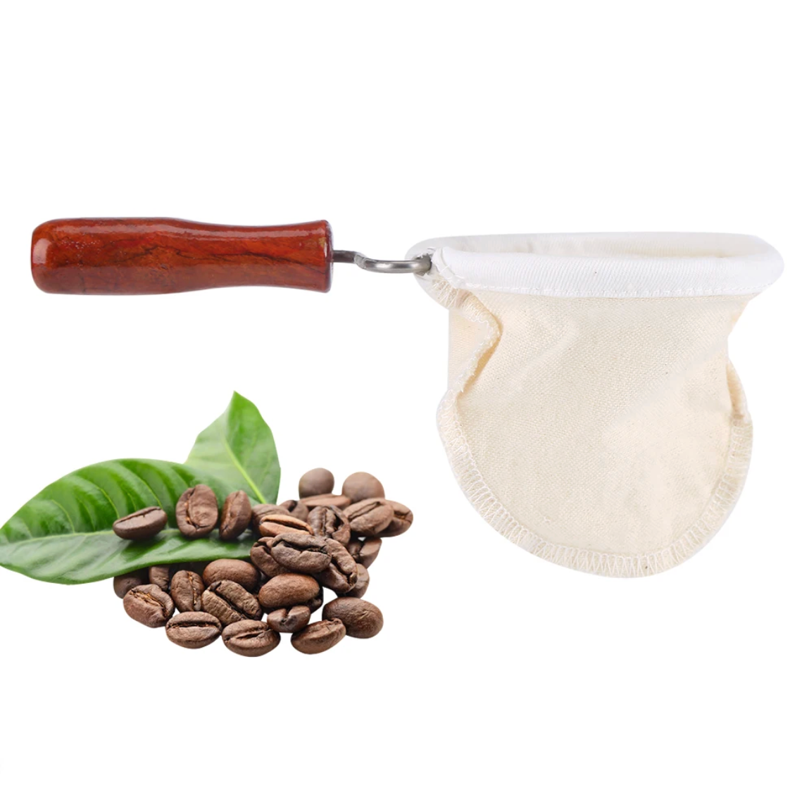Reusable cloth coffee filter with wooden handle beside whole coffee beans and a coffee plant leaf on a white background.