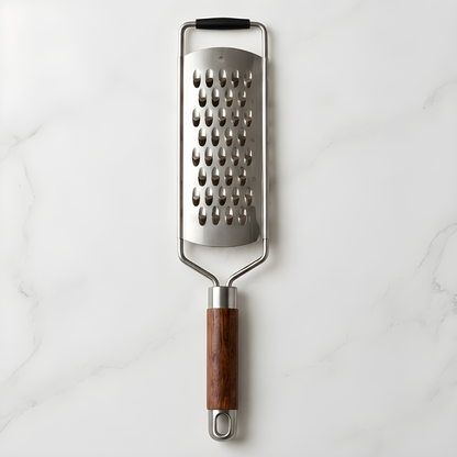 Rosewood handle stainless steel grater on a white marble surface