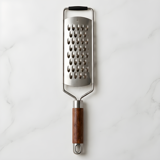 Rosewood handle stainless steel grater on a white marble surface