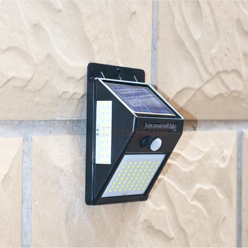 Solar wall light fixture on a textured stone wall