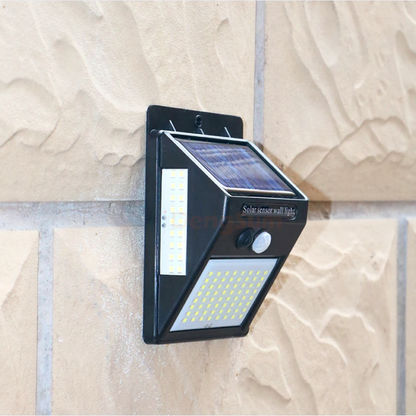 Solar wall light fixture on a textured stone wall