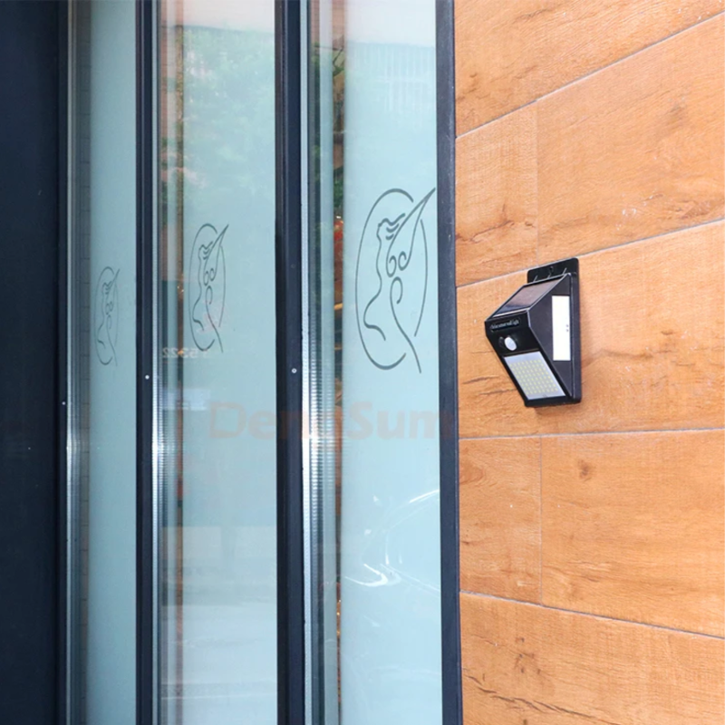 Solar-powered outdoor light fixture on a wooden door with glass panels.