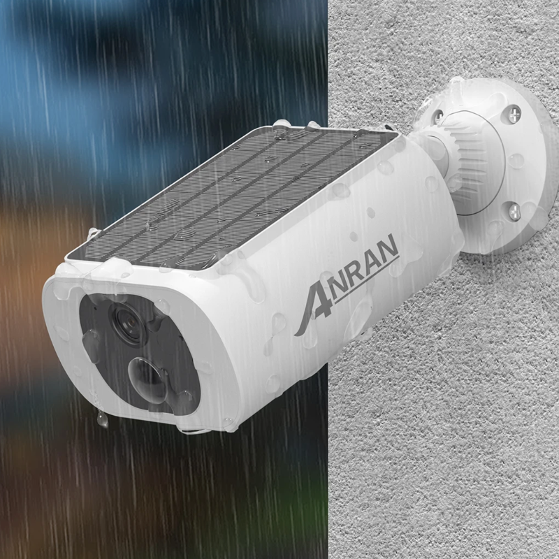 Solar-powered security camera on a textured surface and rainy background.